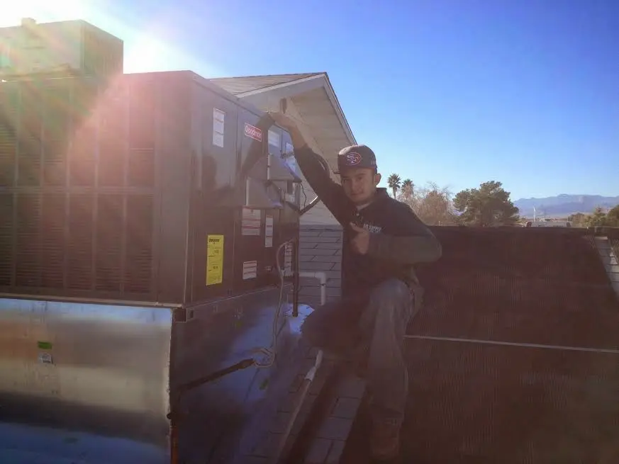 HVAC technician performing Air Duct Cleaning on a rooftop unit in St. Cloud
